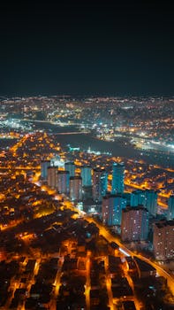 Stunning aerial view of a city illuminated at night with vibrant lights.