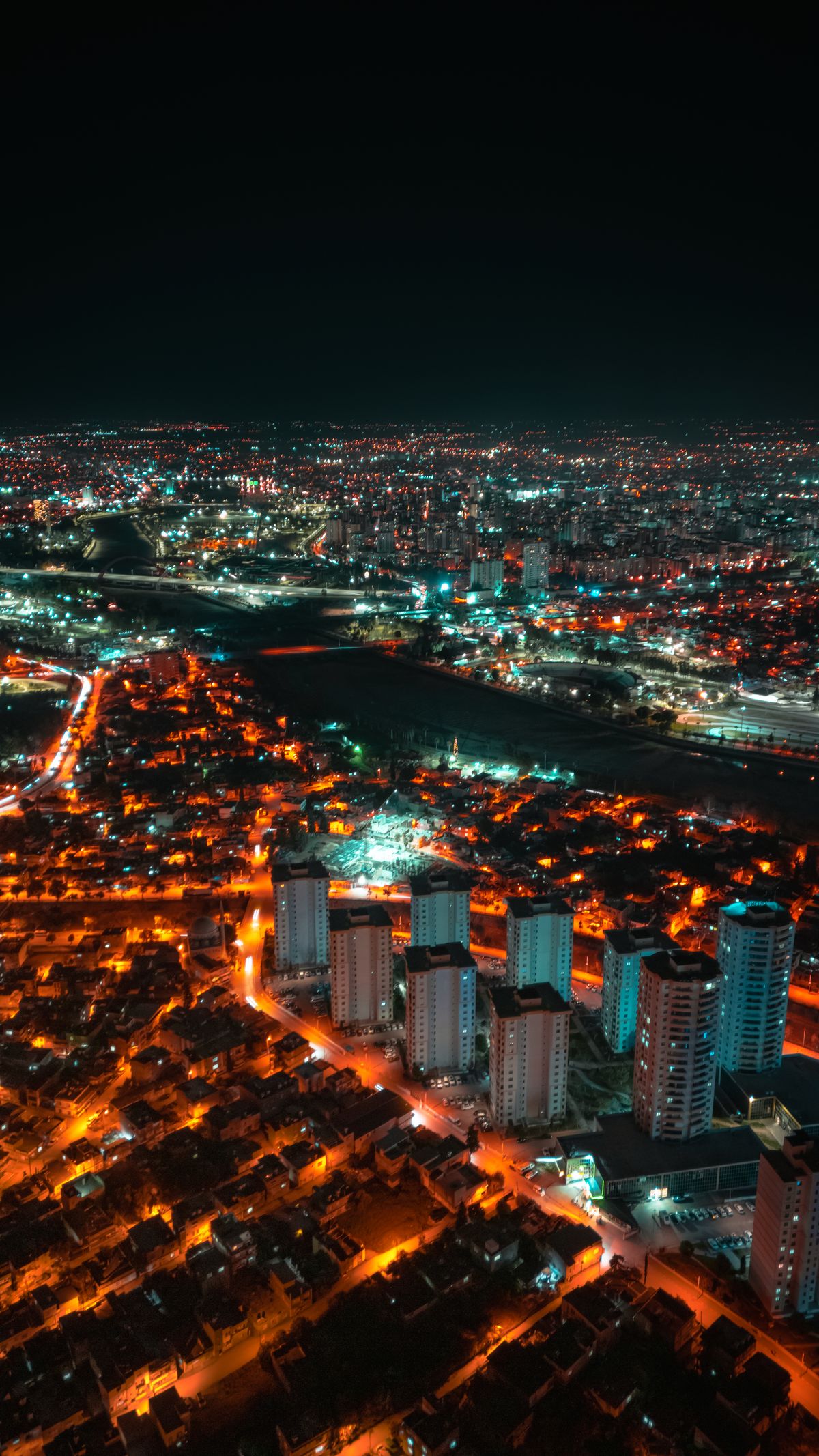 Aerial view of a vibrant illuminated cityscape at night, similar to the famous Mt. Hakodate night view