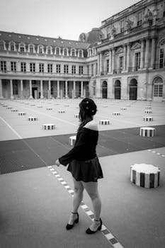 Stylish black and white photo of a woman in Palais Royal, Paris