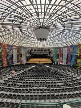 Empty modern concert hall with dome roof and colorful murals