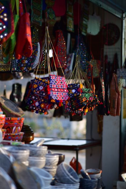 Vibrant display of handcrafted bags and pots in a traditional Pakistani market. - Expert Tips for Shopping on a Budget