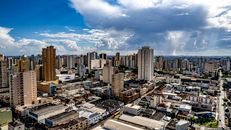 Dynamic aerial shot of Londrina's skyline under a partly cloudy sky, showcasing urban architecture.