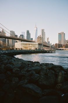 Scenic view of New York City skyline featuring Brooklyn Bridge and waterfront.