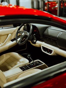 Close-up view of a red sports car's luxurious interior with leather seats and modern dashboard.