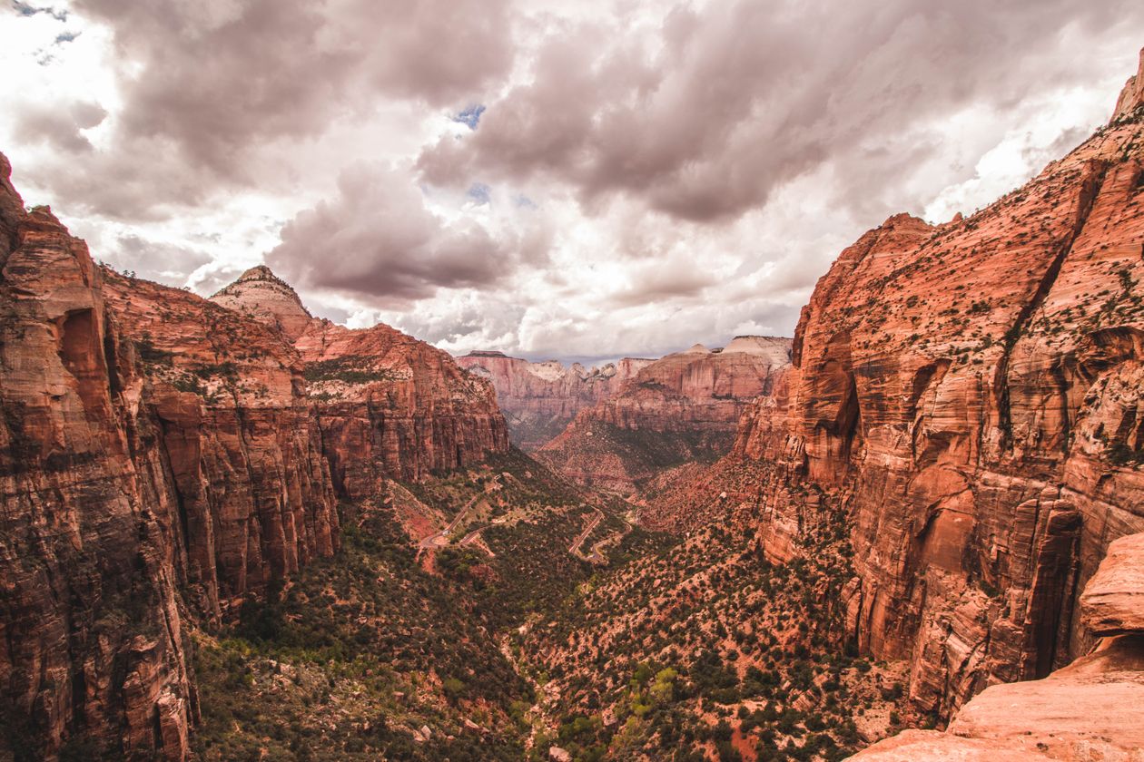 Majestic red rock formations of Zion Canyon under dramatic skies in Utah