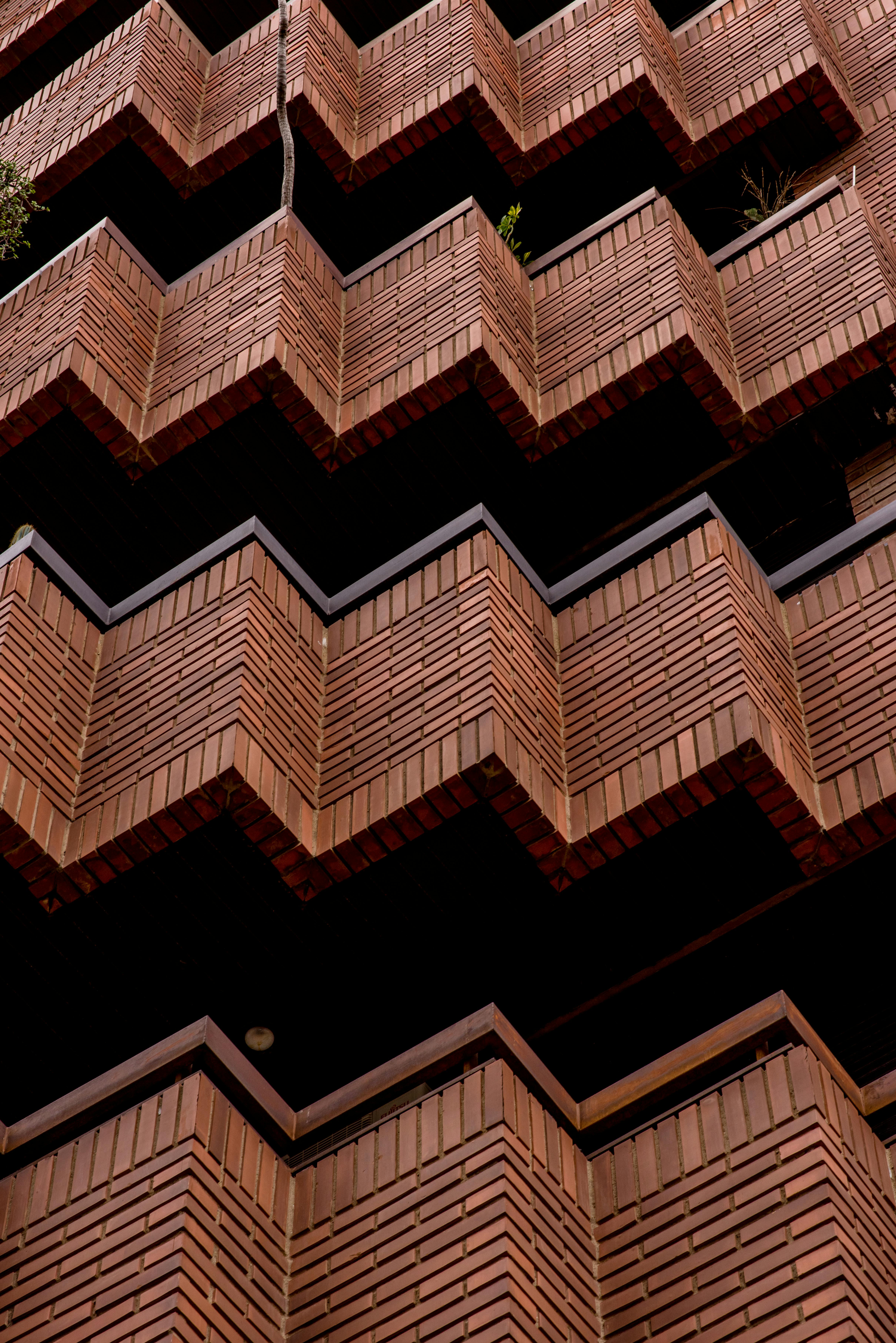 Brick Facade with Geometric Zigzag Design · Free Stock Photo