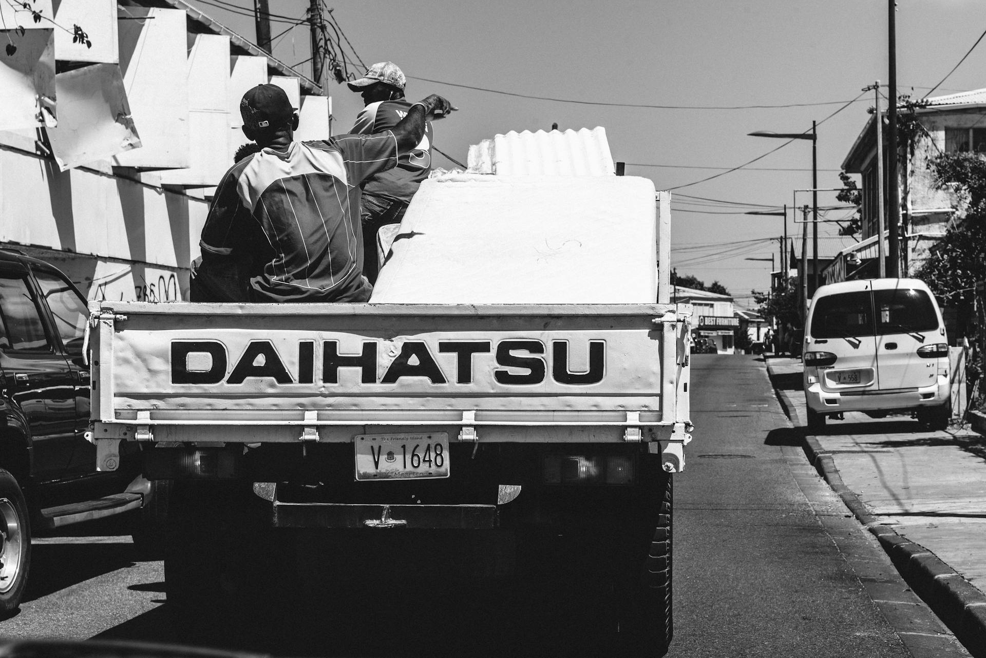People Riding At The Back Of A Truck