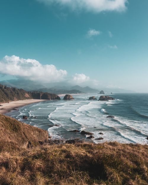 Free Stunning aerial view of Cannon Beach, Oregon, featuring waves crashing along the shoreline. Stock Photo