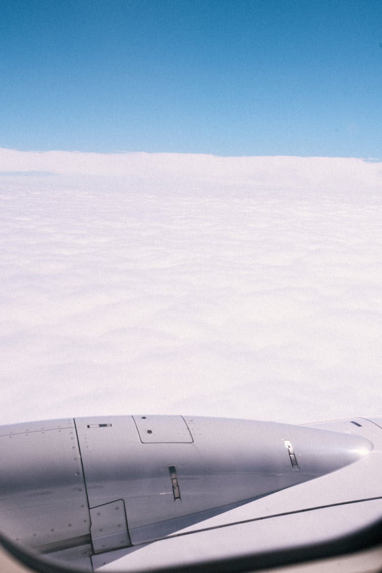 Aerial View Of Thick Clouds From An Aircraft Window 