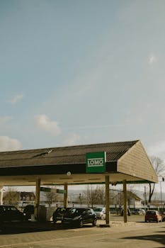 Gas station in Bad Hersfeld, Germany with cars and clear sky.