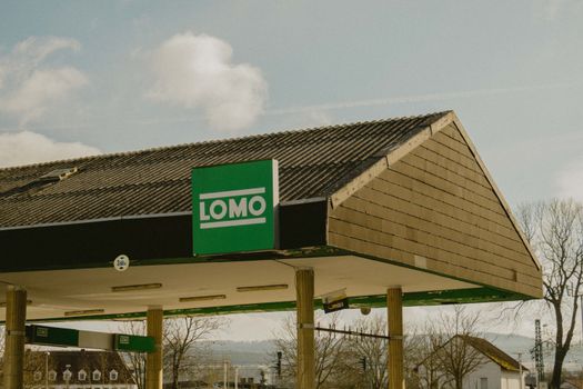 Lomo gas station exterior in Bad Hersfeld, Germany under clear skies.