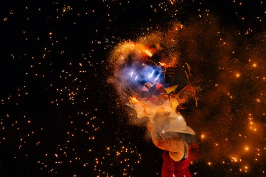 Bright fireworks exploding in vivid colors against a night sky.