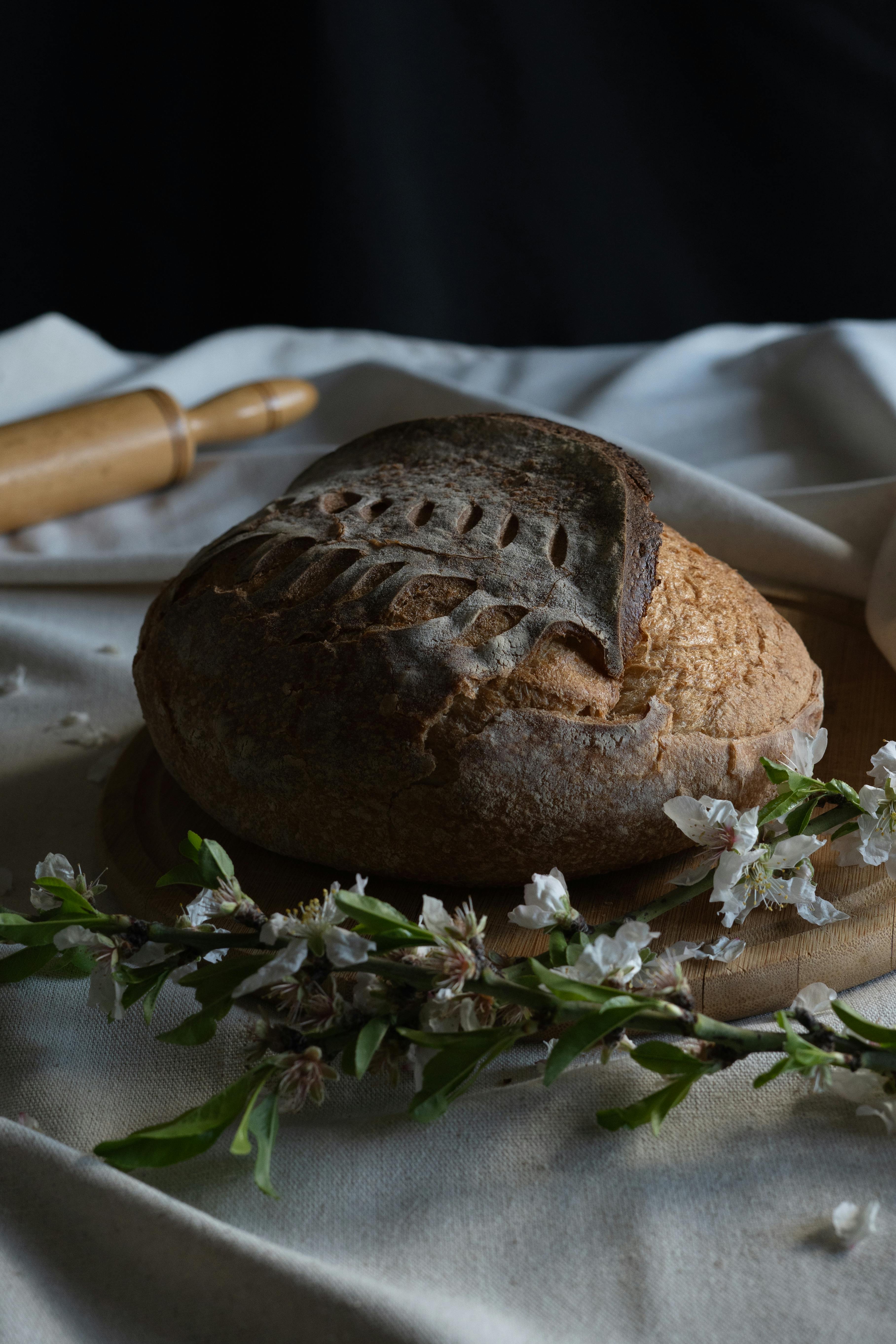 Rustic Artisan Bread with Floral Decor on Table · Free Stock Photo