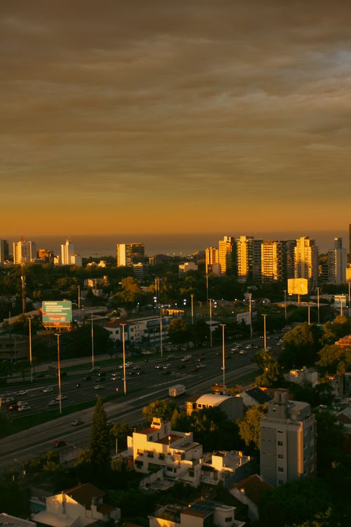Free Dramatic cityscape view at sunset with glowing city lights and high-rise buildings. Stock Photo