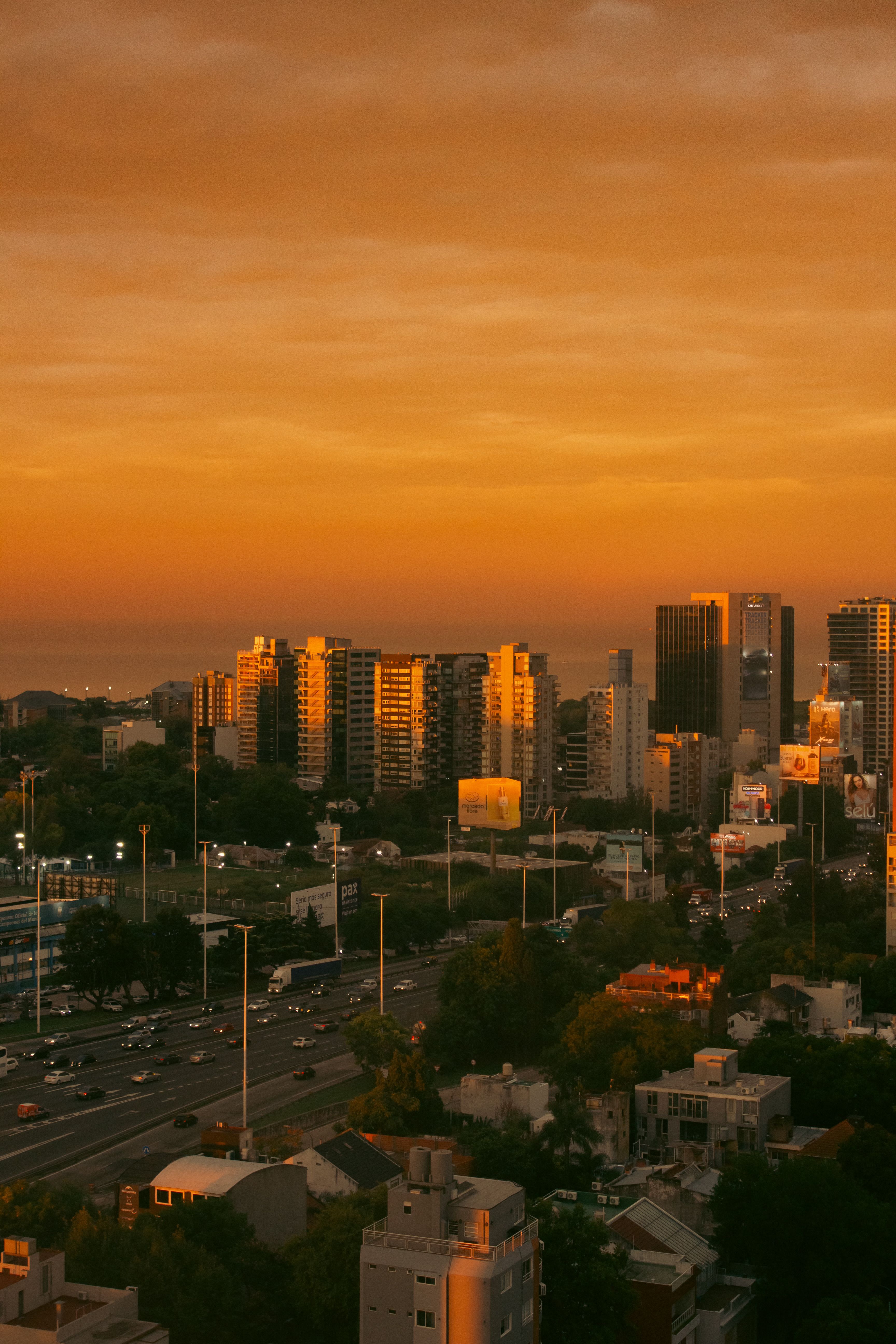 Sunset Over City Skyline with Traffic Below · Free Stock Photo