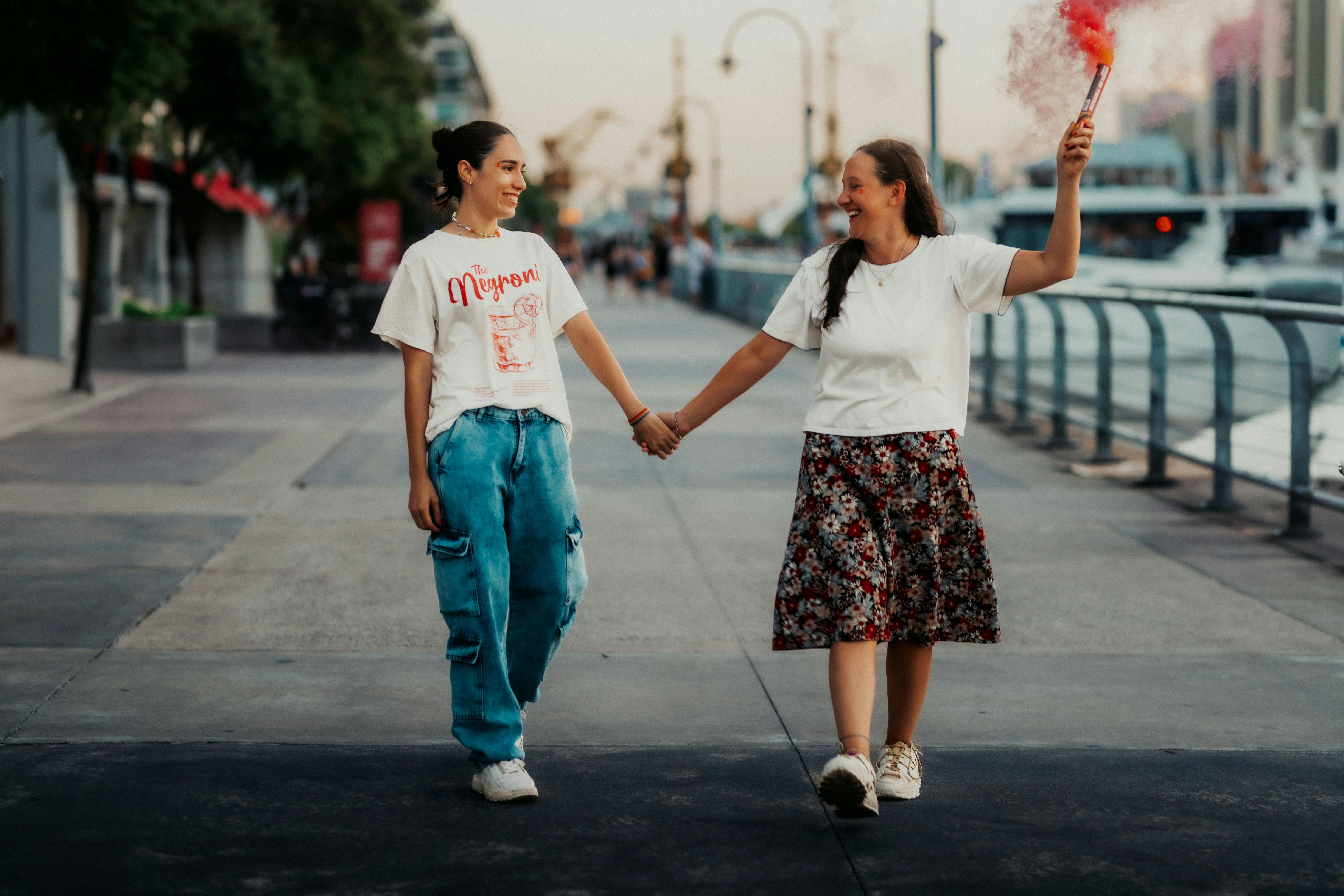 Happy couple holding hands and celebrating with a flare in Buenos Aires.