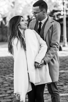 A loving couple shares a warm embrace on a cobblestone street in Buenos Aires, Argentina.