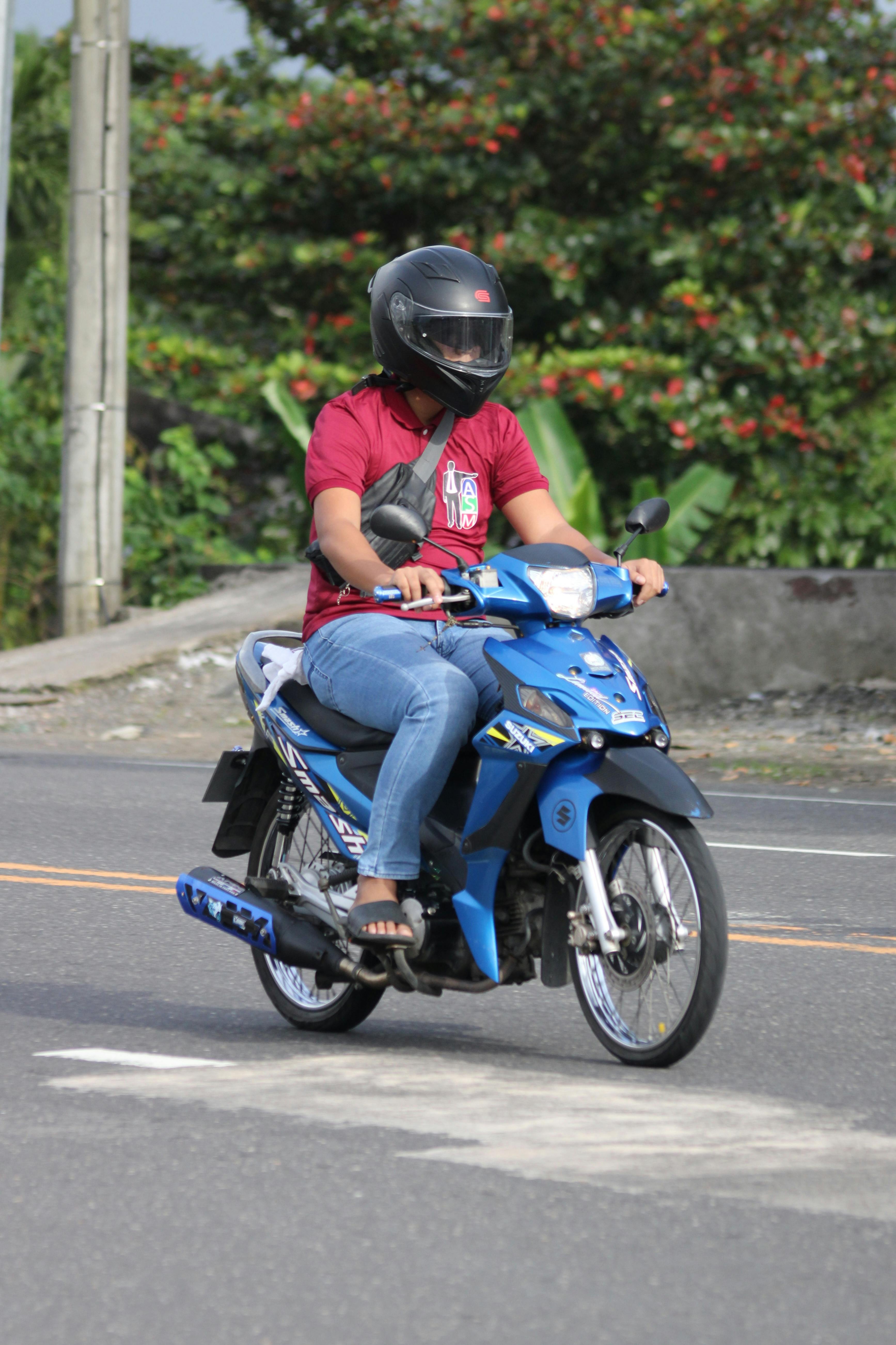 Motorcyclist Riding on Urban Road in Daylight · Free Stock Photo