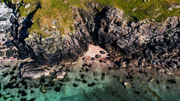 Explore the tranquil beauty of Scotland's rugged coastline with this aerial seaside view.