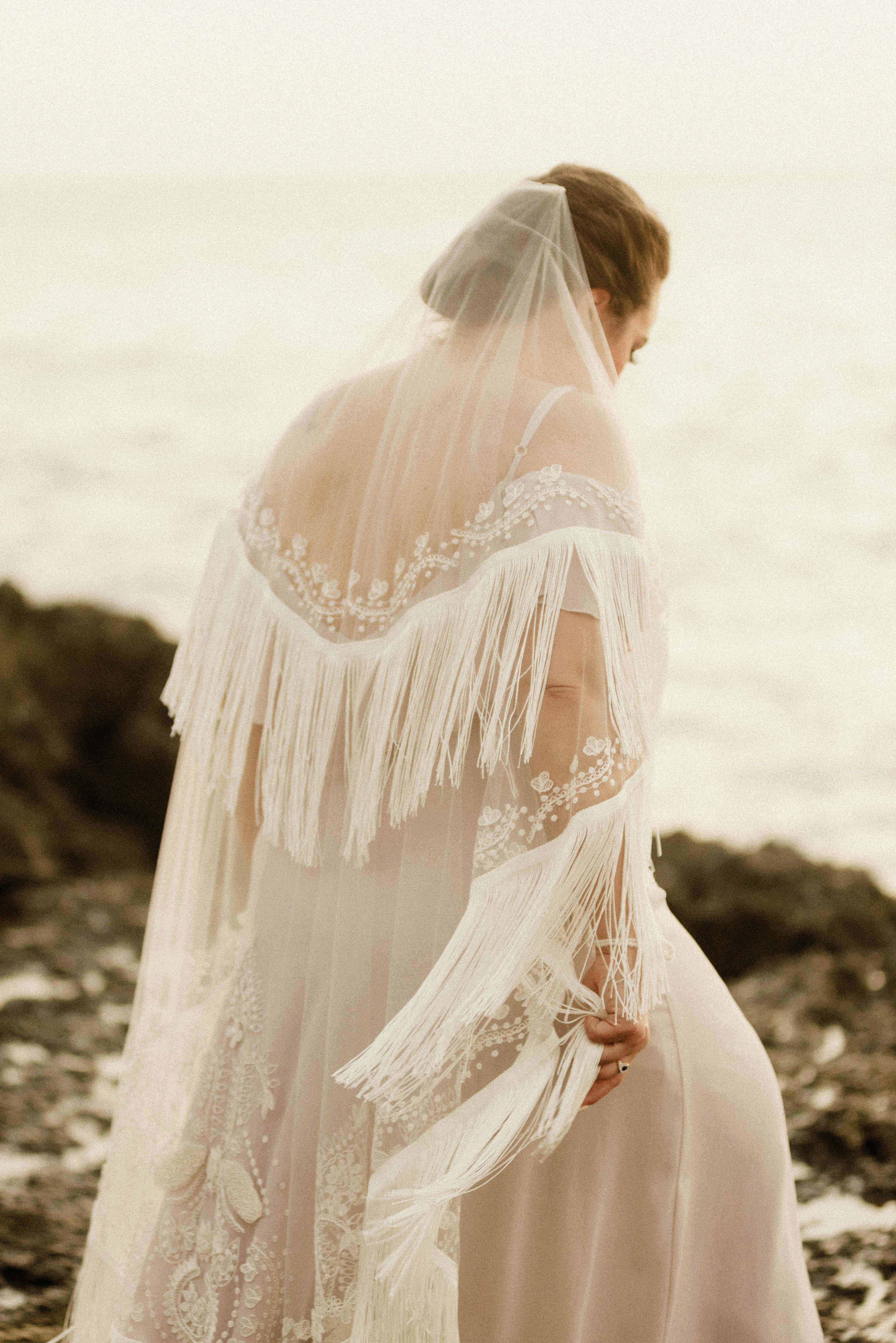 A serene moment of a bride gazing at the ocean in Bali, Indonesia.