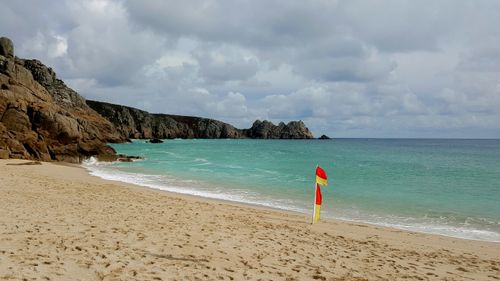Free Scenic view of Porthcurno Beach, England with clear turquoise waters and rocky cliffs. Stock Photo