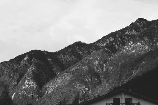 Atmospheric black and white photo of mountains in Chiavenna, Italy.