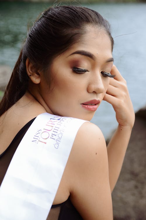 Free Woman Wearing White Sash With Left Hand on Face Stock Photo