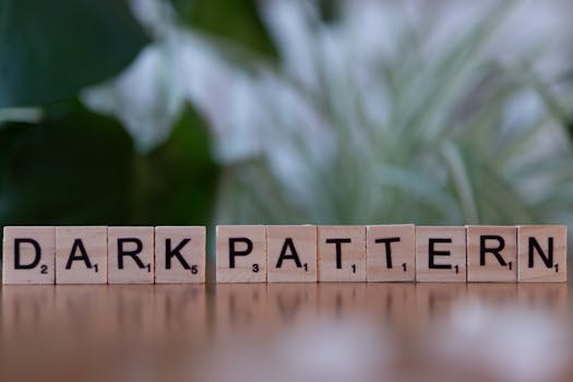 Wooden tiles spelling 'dark pattern' highlighting deceptive design in UX.