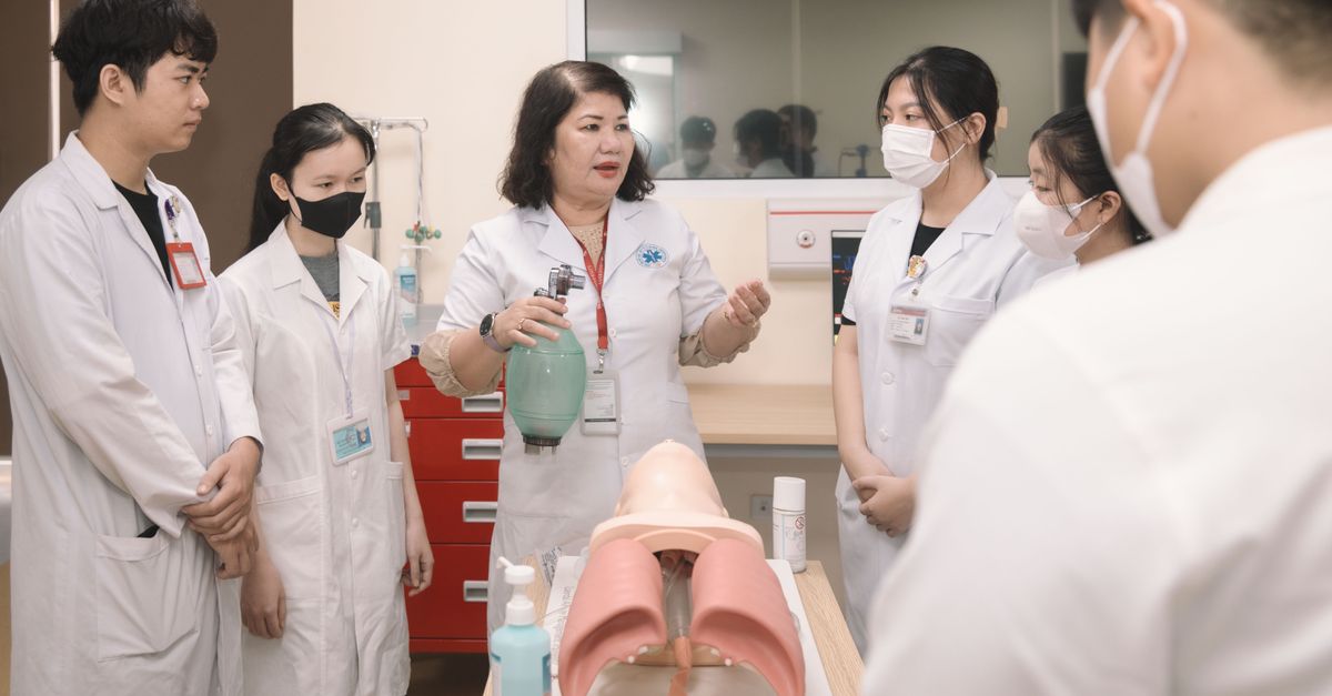 Group of medical students practicing skills with a training mannequin in a classroom setting. - Evidence evidence guide for nac respiratory meta-analysis