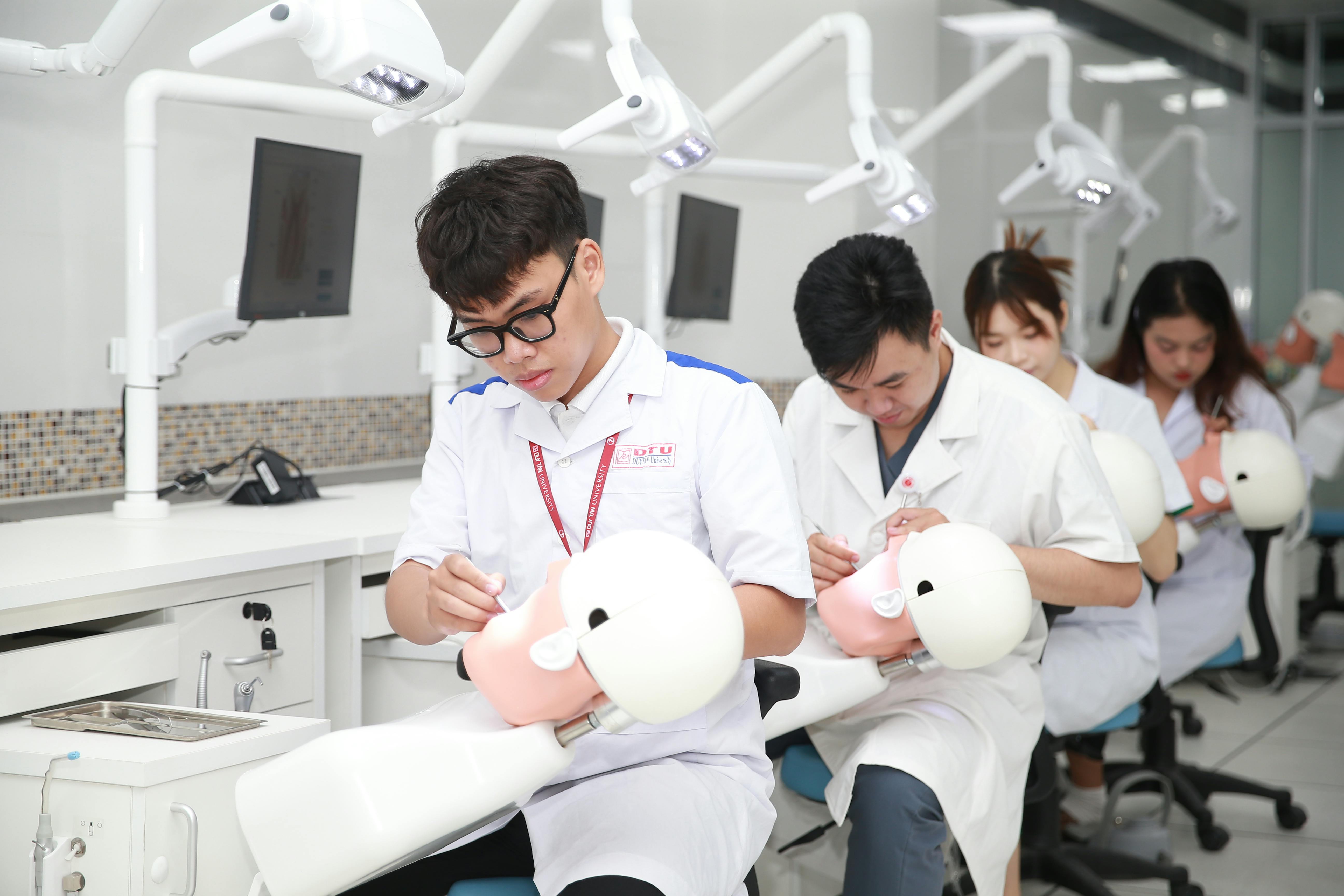 Students sitting in a computer lab taking a university admissions test