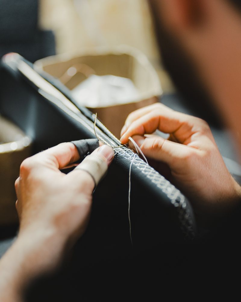 Hand-stitching a leather edge with waxed thread — shoreline vehicles on Pexels