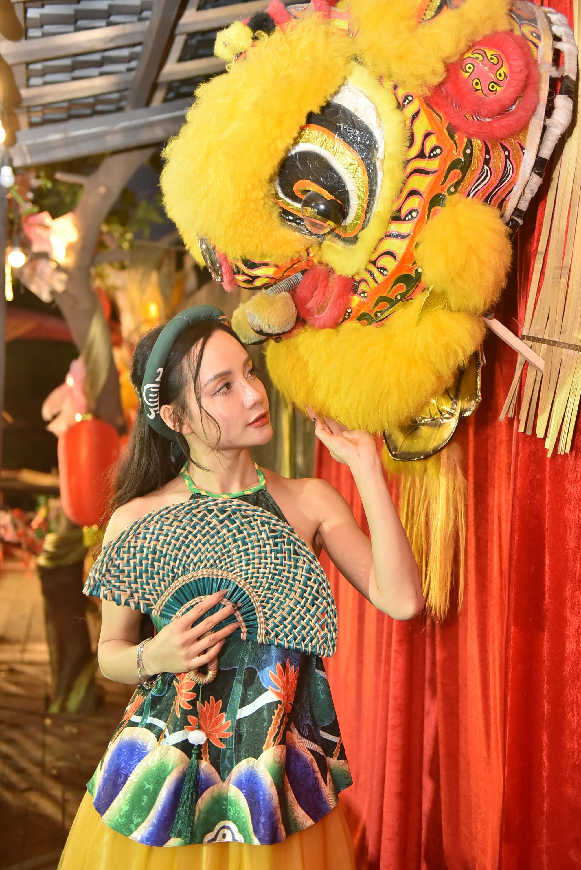 young woman celebrates with traditional chinese lion head