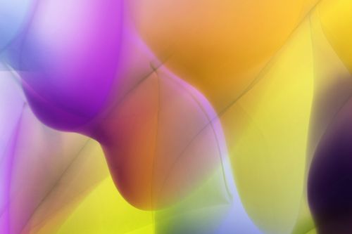 Free Vibrant abstract art with flowing color waves in purple, yellow, and orange. Stock Photo