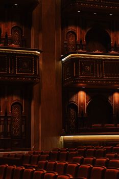 Intricate wooden detailing inside the Royal Opera House Muscat with plush seating