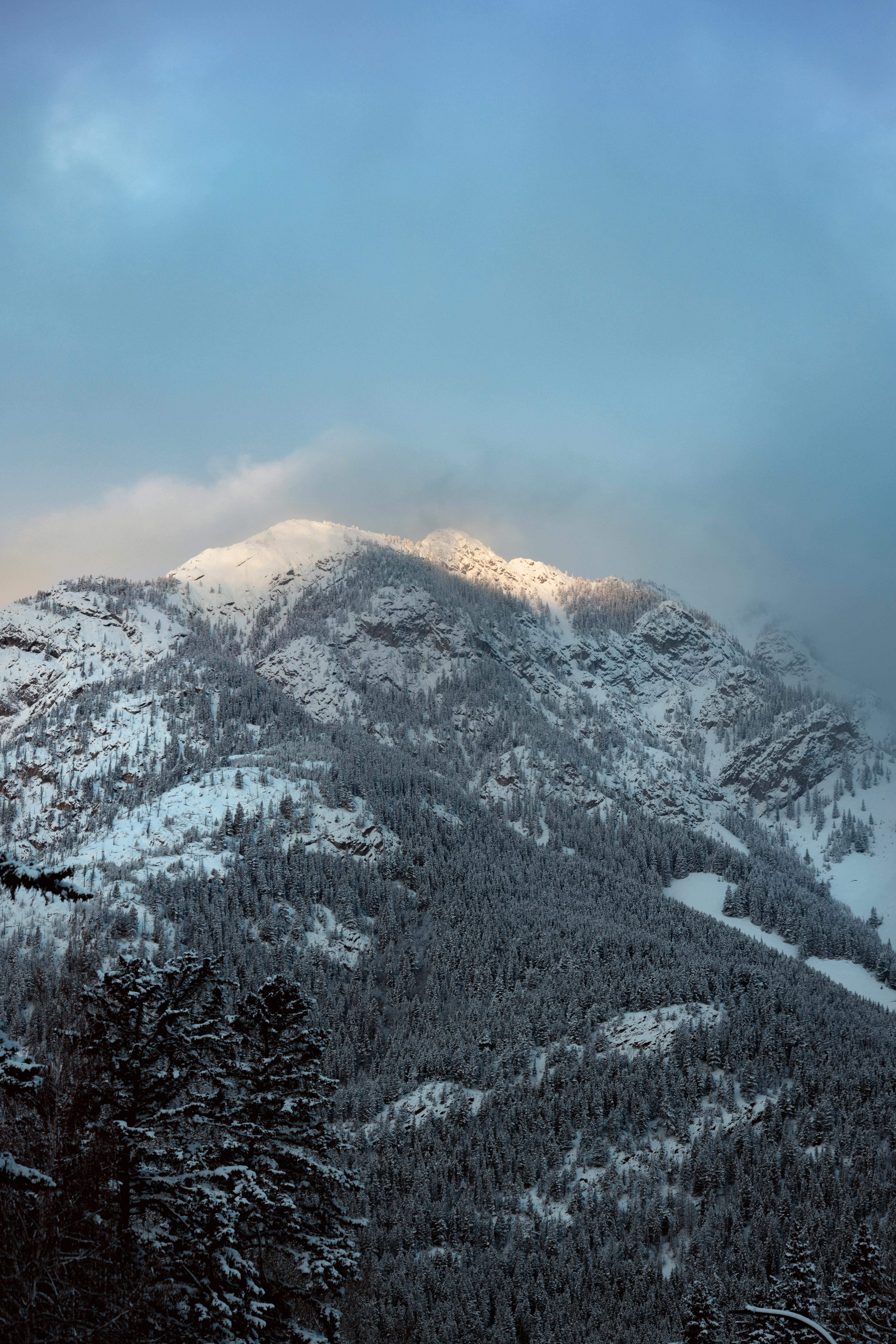 A stunning view of snow-covered mountains in Banff, Alberta, Canada at twilight.