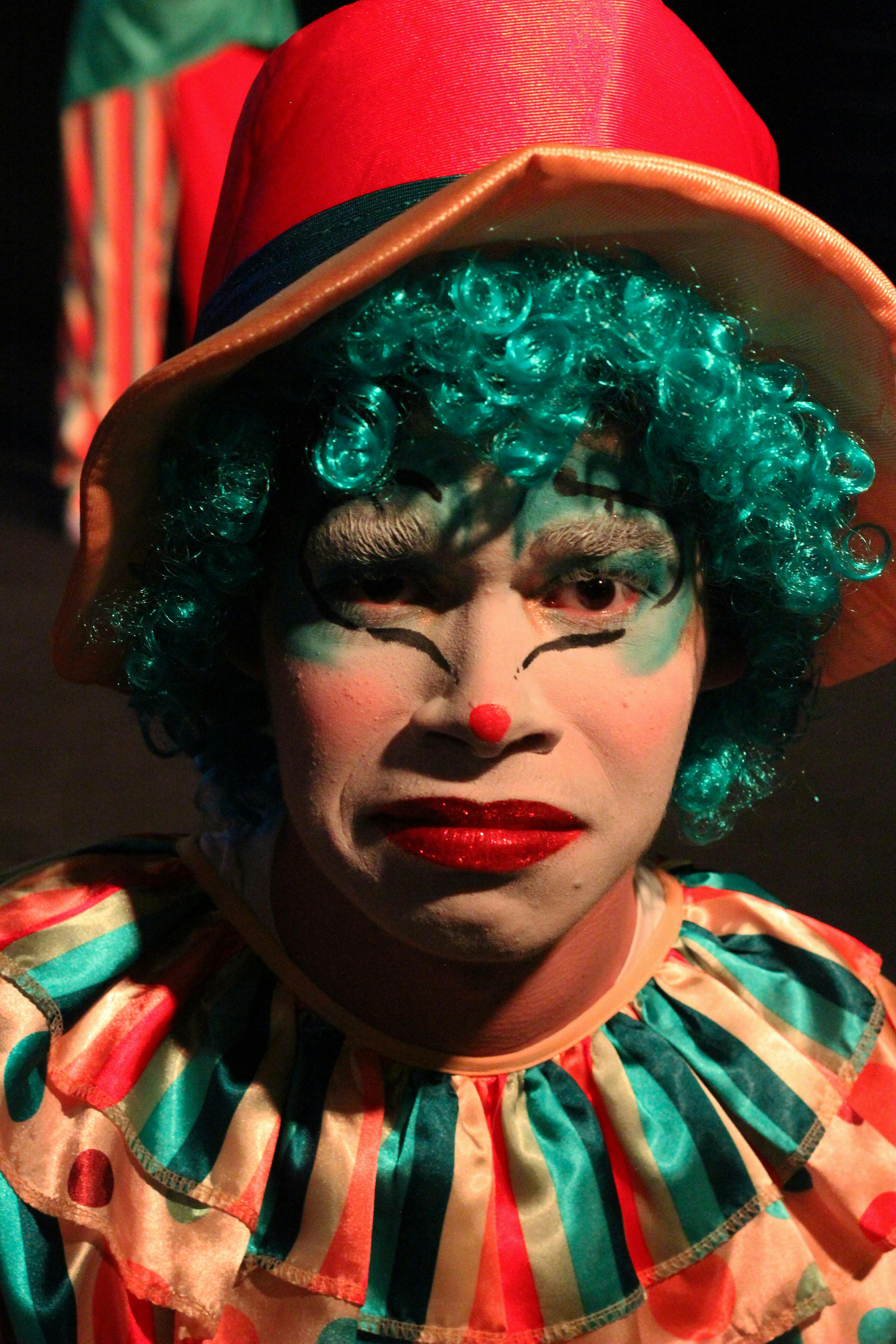 Free Colorful clown with expressive face in circus costume, exuding emotion and drama. Stock Photo