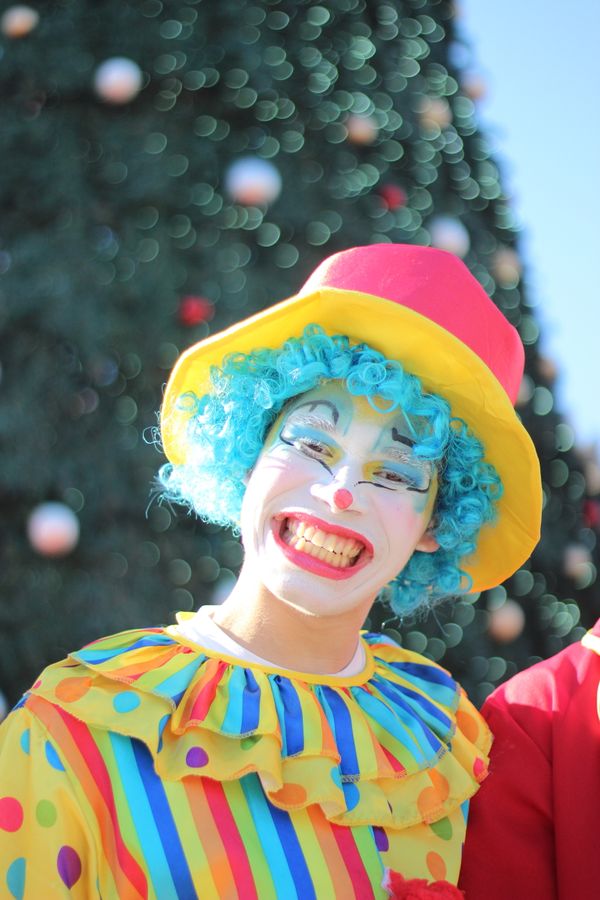 Colorful Clown Entertainer with Big Smile Outdoors · Free Stock Photo