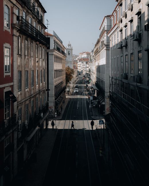 Street view of Lisbon, Portugal showcasing classic architecture and urban life.