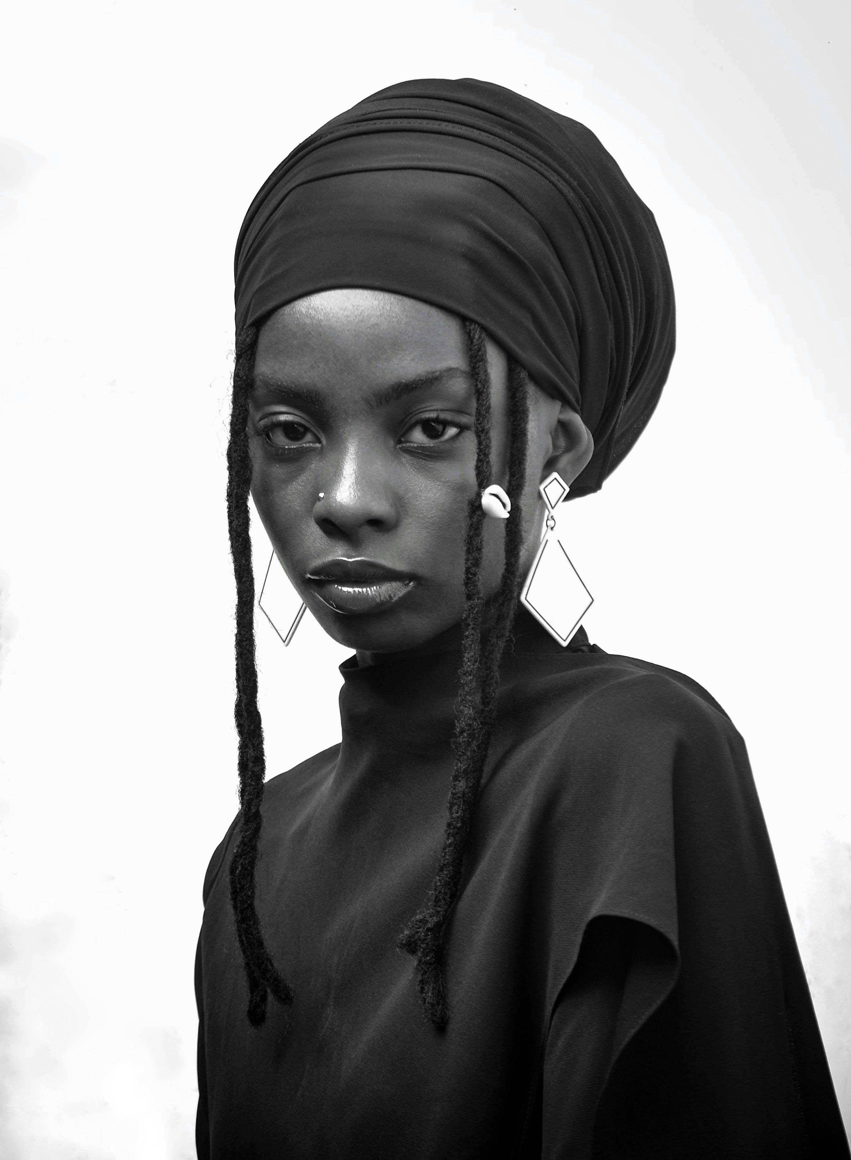 Stunning portrait of an African woman in traditional headwrap and jewelry.