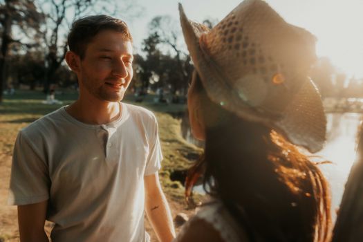 Young couple enjoying a sunny day in a Buenos Aires park, experiencing love.