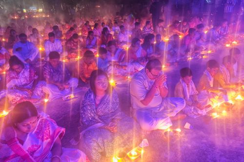 Free Vibrant gathering of people in Kachua, West Bengal, engaging in a traditional prayer ceremony. Stock Photo