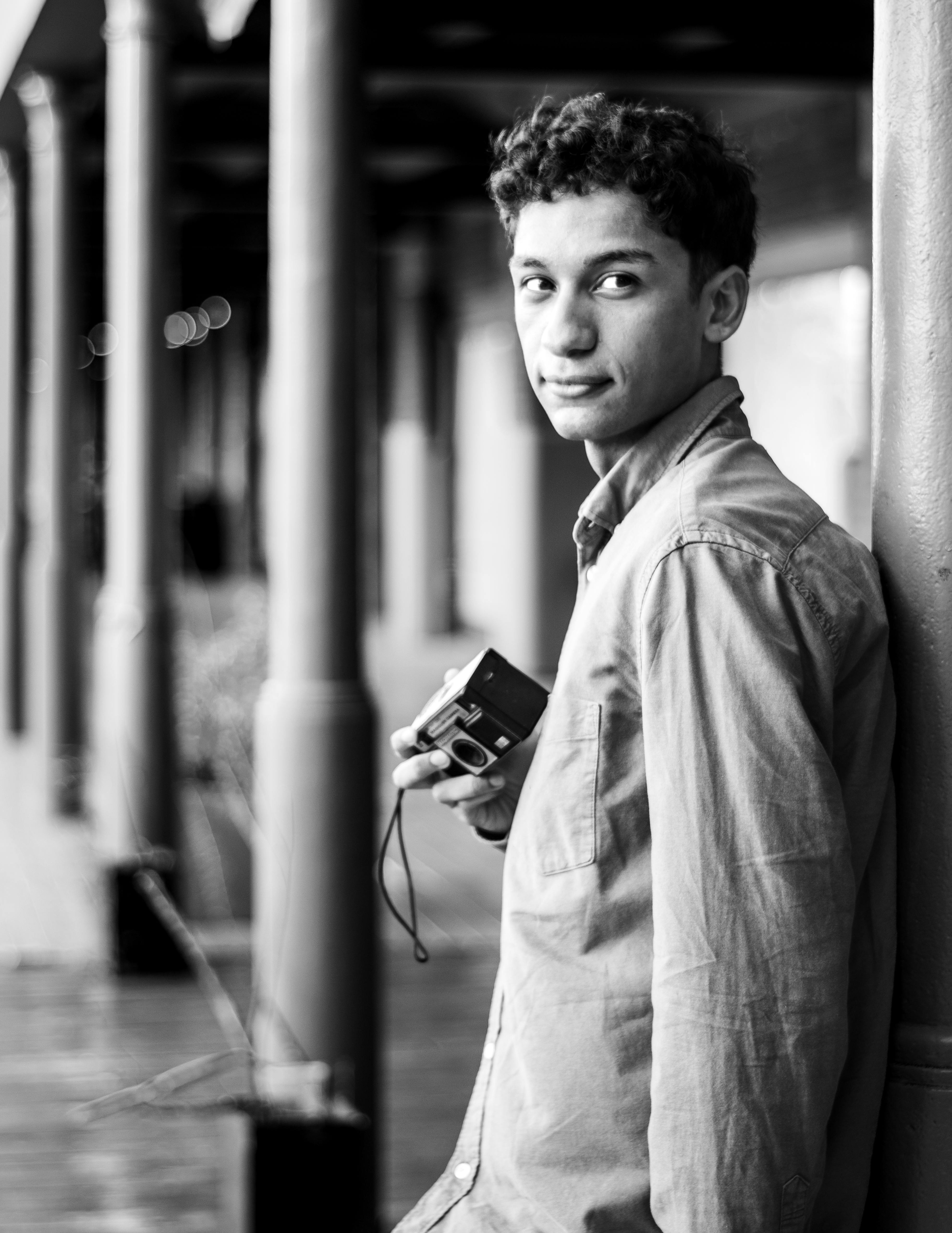 monochrome portrait of man with vintage camera