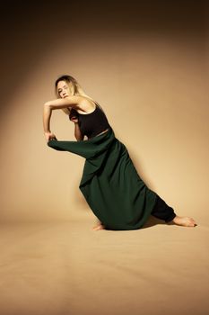 Elegant pose of a dancer in a unique stance, expressing modern dance dynamics.