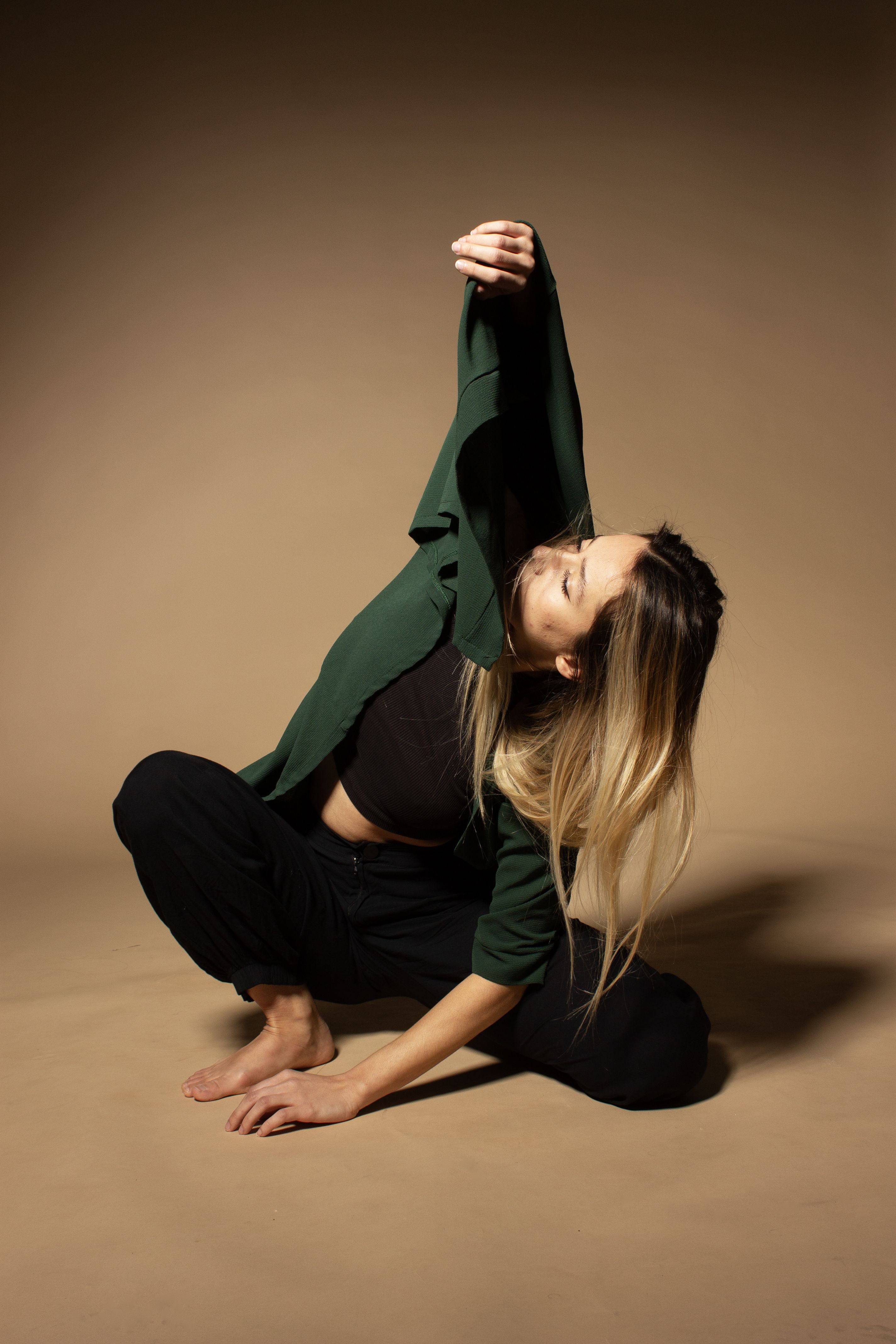elegant woman posing in studio with dramatic lighting
