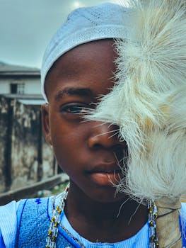 Close-up of a child holding a decorative fan, wearing traditional attire.