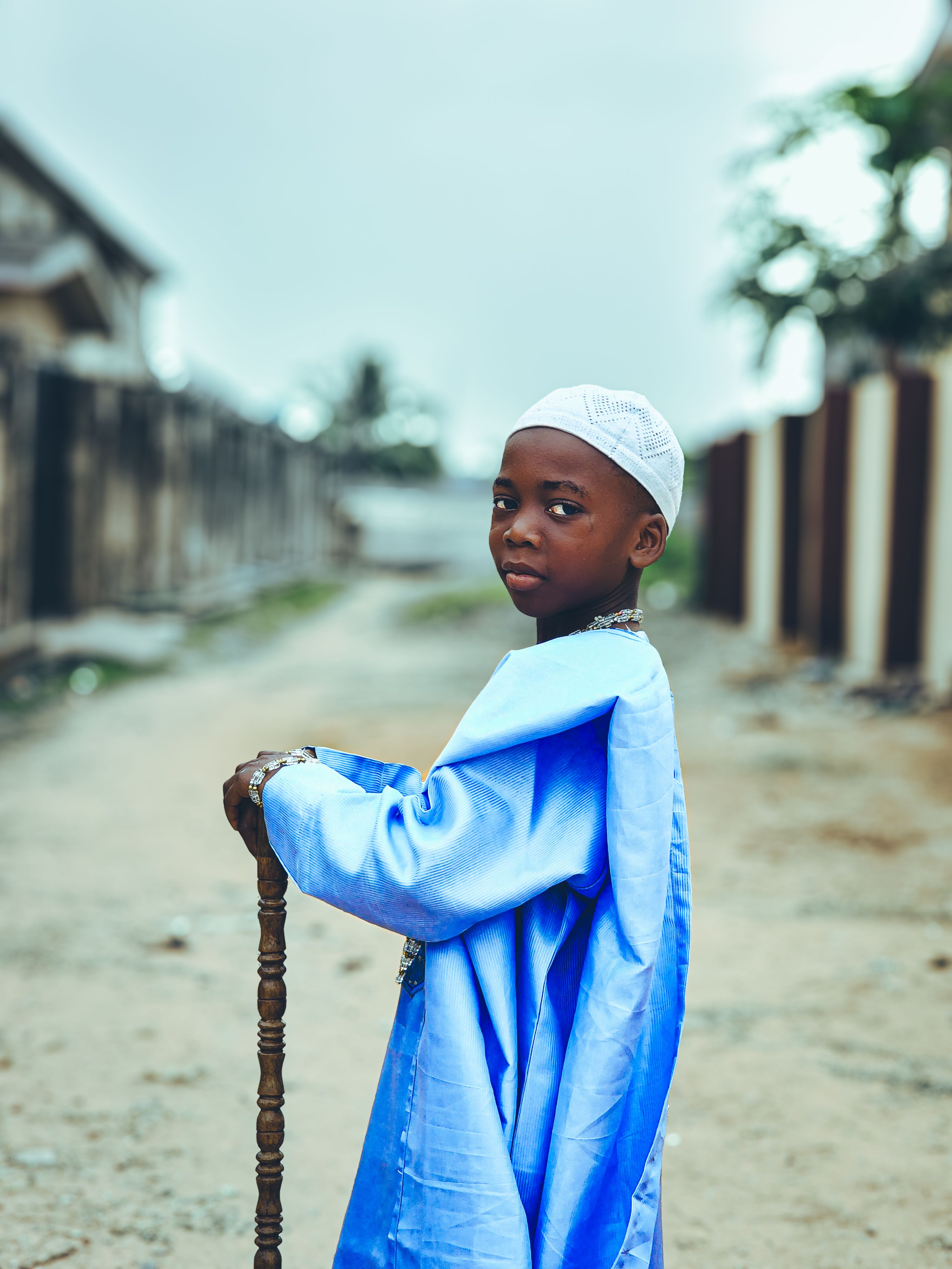 Young boy in traditional blue attire outdoors · Free Stock Photo