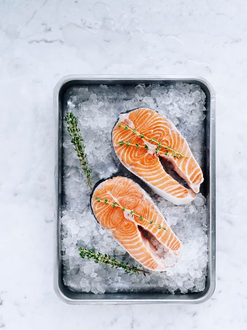 Free Closeup of raw salmon fillets with thyme on ice, perfect for gourmet meals. Stock Photo