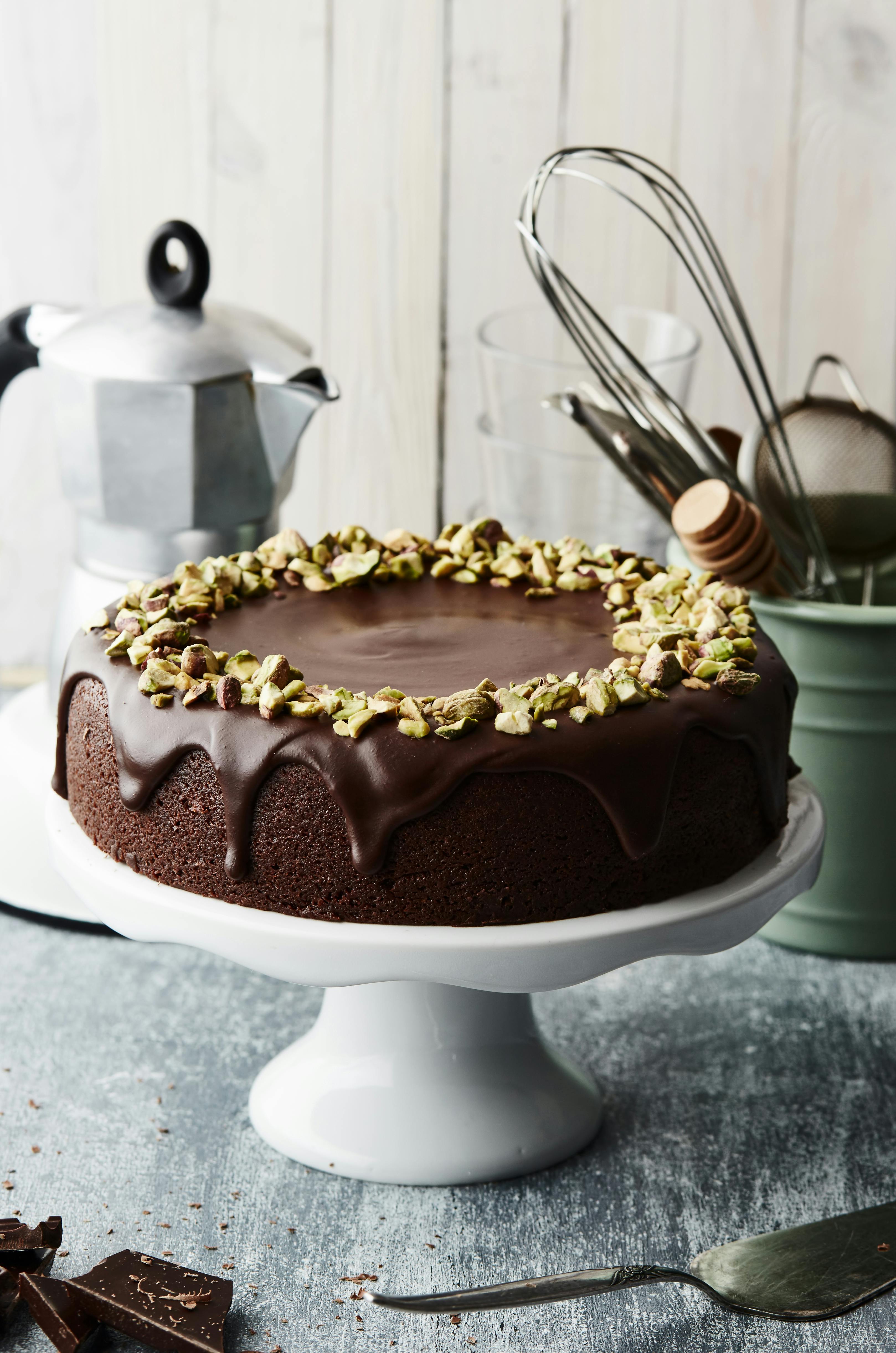 Indulge in this luxurious chocolate cake topped with crunchy pistachios.