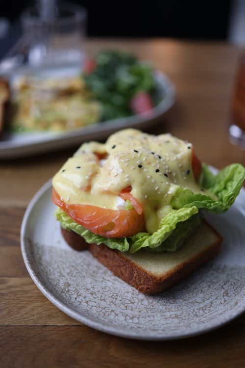 Free Open-faced sandwich with salmon, lettuce, and creamy sauce on a plate, perfect for brunch. Stock Photo
