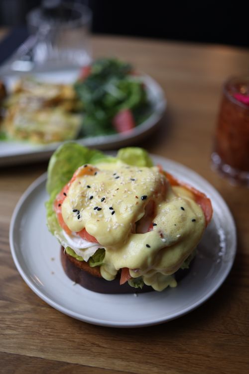 Free Delicious eggs benedict with creamy hollandaise sauce and sesame seeds. Stock Photo